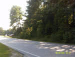 A road in Henderson NC with cars parked next to it on 8 Ruin Creek Road.
