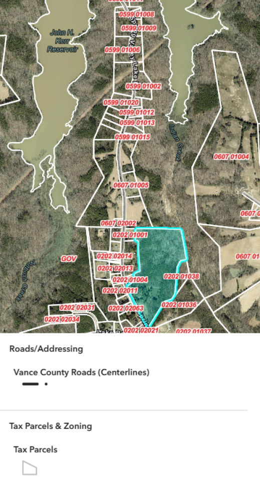 This image depicts a map overlay with marked property lines, including parcel identification numbers, zoning designations, and the outline of roads in vance county. one parcel is highlighted in teal.
