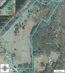 Aerial view of a 13.5-acre parcel of land on Graystone Road, Henderson NC with delineated boundaries, featuring varying terrain including cleared areas and wooded sections, and a compass rose on