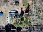 Aerial view of a property in Henderson NC, with buildings, delineated by red boundary lines and marked with parcel identification numbers at 184 Daniel Boone Trail.