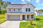 A two-story house at 91 Springwater Rd, Henderson NC, with a gray exterior and white trim, featuring a double garage and a front porch, surrounded by a grassy lawn under a clear