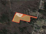 Satellite view of a forested area with a highlighted plot outlined in red. The plot is subdivided into four sections labeled WCL, WBD, LOB, and WAB. The area is adjacent to Julie McKnight Road and Montgomery Road in Kittrell. Nearby residential structures are visible.