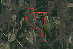 An aerial view of a rural area in Kittrell shows a large piece of land outlined in red. Surrounding the outlined area are patches of forest and open fields. Visible roads include Joy Wilkins Road, Prospect Hill Road, and 0 Julie McKnight Road. The Tar River is located at the bottom right of the image.
