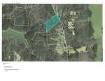Aerial map view shows a wooded area with a highlighted parcel of land bordered in blue, located near Lot 6 County Line Park Road. Surrounding the parcel are other plots and roads, with scattered houses amidst the trees, just outside of Manson.