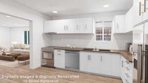 A modern kitchen with white cabinets, stainless steel appliances, and brown countertops. A couch is visible in the adjacent room. The image is digitally staged to show renovation potential.