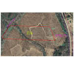 An aerial map shows a tract of land outlined in red near 7717 Cornwall Road, with parcel size details labeled. Roads are marked on the right side, while the surrounding terrain near Oxford appears natural with visible vegetation.