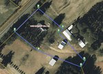 An aerial view of a property boundary highlighted in blue reveals a house, several outbuildings, and surrounding trees in Franklinton. A road runs along one side, with the label "3168 Cannady Mill Rd" clearly visible within the boundary.