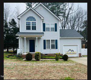 Two-story gray house with blue shutters and a white garage at 201 Korbin Court. Front yard with shrubs and a small porch. Overcast sky and leafless trees in the backdrop of this Creedmoor residence. Text at the bottom reads "Listed Exclusively By: Doward Property Management.