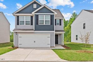Nestled on 109 Anaheim Street, this two-story suburban house boasts charming gray and blue siding with white trim and a cozy porch. The spacious two-car garage complements the well-manicured lawn. Set in the picturesque Oxford neighborhood, it basks under a clear sky dotted with a few clouds.