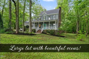 A two-story house with a gabled roof sits at 3644 Whitwinds Way, surrounded by lush green trees. A covered porch on the front has white railings. The spacious, well-maintained lawn offers serene Franklinton views. Text on the photo reads: "Large lot with beautiful views!.