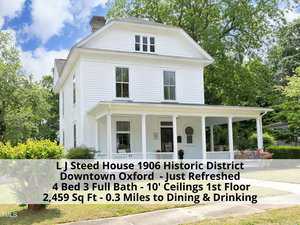 A historic white house with a large porch and lush green surroundings stands proudly on 114 Rectory Street. The text overlay details: L J Steed House, 1906, in Downtown Oxford. Features include 4 bedrooms, 3 full baths, and 2,459 sq ft. Recently refreshed and close to dining.