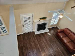 A living room with a fireplace and a leather couch.