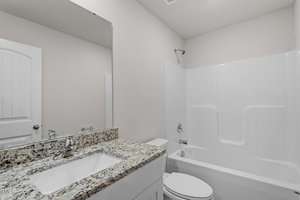 Modern bathroom with white walls and fixtures. Features a granite countertop with a sink, a large mirror, a toilet, and a white bathtub with a shower curtain rod above. The space is bright and clean, with a door visible to the left.
