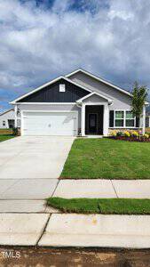 Located at 819 Rhino Bend, this modern single-story house boasts a dark gray and white exterior. It features a two-car garage, a concrete driveway, and a neatly maintained green lawn. The sky over Oxford is partly cloudy.
