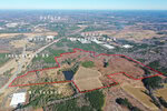 Aerial view of a large, undeveloped tract of land outlined in red near Oxford on 3129 Montague Centre Road. Visible landmarks include Walmart, Oxford Industrial Park, NC Techno, and Interstate 85. The surrounding area features wooded and open fields.