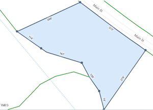 A diagram of a plot of land with various measurements depicted along the edges. The plot is bordered by Main Street, and includes angles and lengths in feet such as 269', 313', and 278'. Green lines outline the perimeter roads and boundaries.