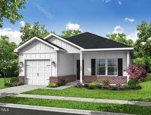 Located at 303 E C Street in Butner, this modern single-story house features white siding complemented by red brick accents and a sleek black shingle roof. It includes a one-car garage and a concrete driveway leading to a yard with vibrant green grass, trimmed bushes, and small trees under a partly cloudy sky.