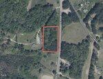 Aerial view of a wooded area bordered in red on 0 Sims Bridge Road, Kittrell, between Sims Bridge Rd and a clearing. Surroundings include trees, open spaces, a few buildings, and nearby roads labeled Sims Bridge Rd and Rocky Ford Rd.