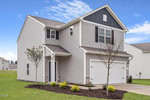 A two-story modern suburban house at 903 Rhino Bend, Oxford, with gray siding, white trim, and a white double garage. The front yard features young trees, shrubs, and mulch with a concrete driveway leading to the garage.