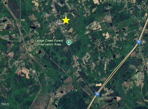 A satellite map showing rural green areas, highways, and scattered buildings. A yellow star marks the location labeled "Stem." The Ledge Creek Forest Conservation Area and Interstate 85 are also visible.