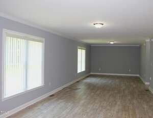 A room with a wood floor and a light fixture.