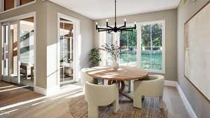 A modern dining room with a round wooden table, four cream-colored chairs, a black chandelier, large windows showing a green yard, and a vase with branches on the table. Light wood floors and neutral walls are visible.