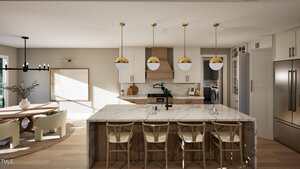 Modern kitchen with a marble island, four wooden chairs, gold and white pendant lights, white cabinets, stainless steel appliances, and a dining area with a round table and beige chairs. Laundry room visible in the background.