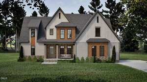 A two-story modern farmhouse at 1123 Dovefield Lane in Youngsville features gray roofing, white and wood siding, large windows, a covered front porch, stone accents, shrubs, a driveway, and a backdrop of green grass and tall trees.