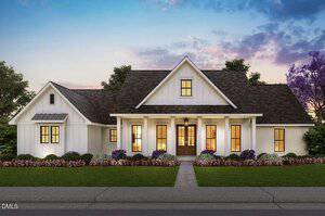 A white, single-story house at 4465 Poppy Mallow Lane, Oxford, features a gabled roof, columned front porch, multiple windows, and a well-maintained lawn with flower beds, beautifully captured at sunset.