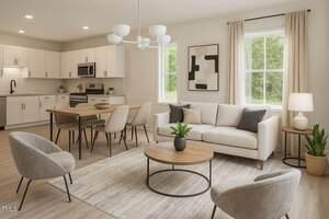 A modern open-concept living and dining area featuring a white sofa, two gray chairs, a wooden coffee table, a dining table with four chairs, neutral decor, large windows, and a kitchen with white cabinets and stainless steel appliances.