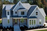 A two-story gray house with white trim at 3922 Cedar Knolls Drive, Youngsville, features multiple gabled roofs, large windows, a covered front porch with wooden pillars, and a landscaped yard, photographed on a sunny day.