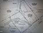 A black and white property survey map of Oxford shows boundary lines, labeled parcels including 0 E Quail Ridge Road, topographic lines, flood zones, and surveyor notes. Various labeled points, elevations, and reference numbers are visible throughout the document.