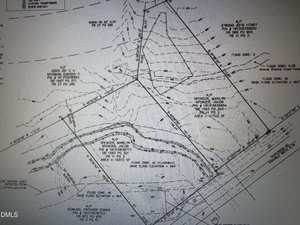 A black and white property survey map of Oxford shows boundary lines, labeled parcels including 0 E Quail Ridge Road, topographic lines, flood zones, and surveyor notes. Various labeled points, elevations, and reference numbers are visible throughout the document.