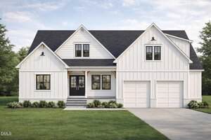 A modern white two-story house with black trim, a dark roof, double front doors, large front-facing windows, and a double garage at 104 Woodland Drive in Oxford. Surrounded by neatly trimmed grass and beautiful landscaping.