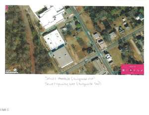 Aerial map showing a neighborhood with outlined properties, streets, and buildings. Turquoise dots and lines indicate sewer manholes and sewer gravity lines. Handwritten notes label the turquoise markings. A pink map legend is visible on the right.