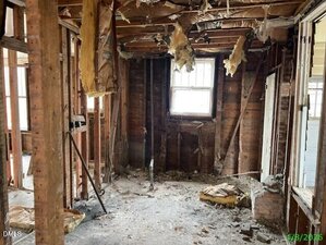 A room with a window and a wood frame.