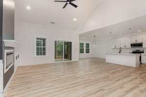 A large room with a wood floor and ceiling fan.