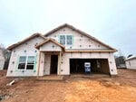 A partially constructed house at 13 Bee Balm Court, Youngsville, features exterior walls covered in building wrap, an open garage, exposed framework, and bare dirt in the front yard. Construction materials and tools are visible inside the garage.
