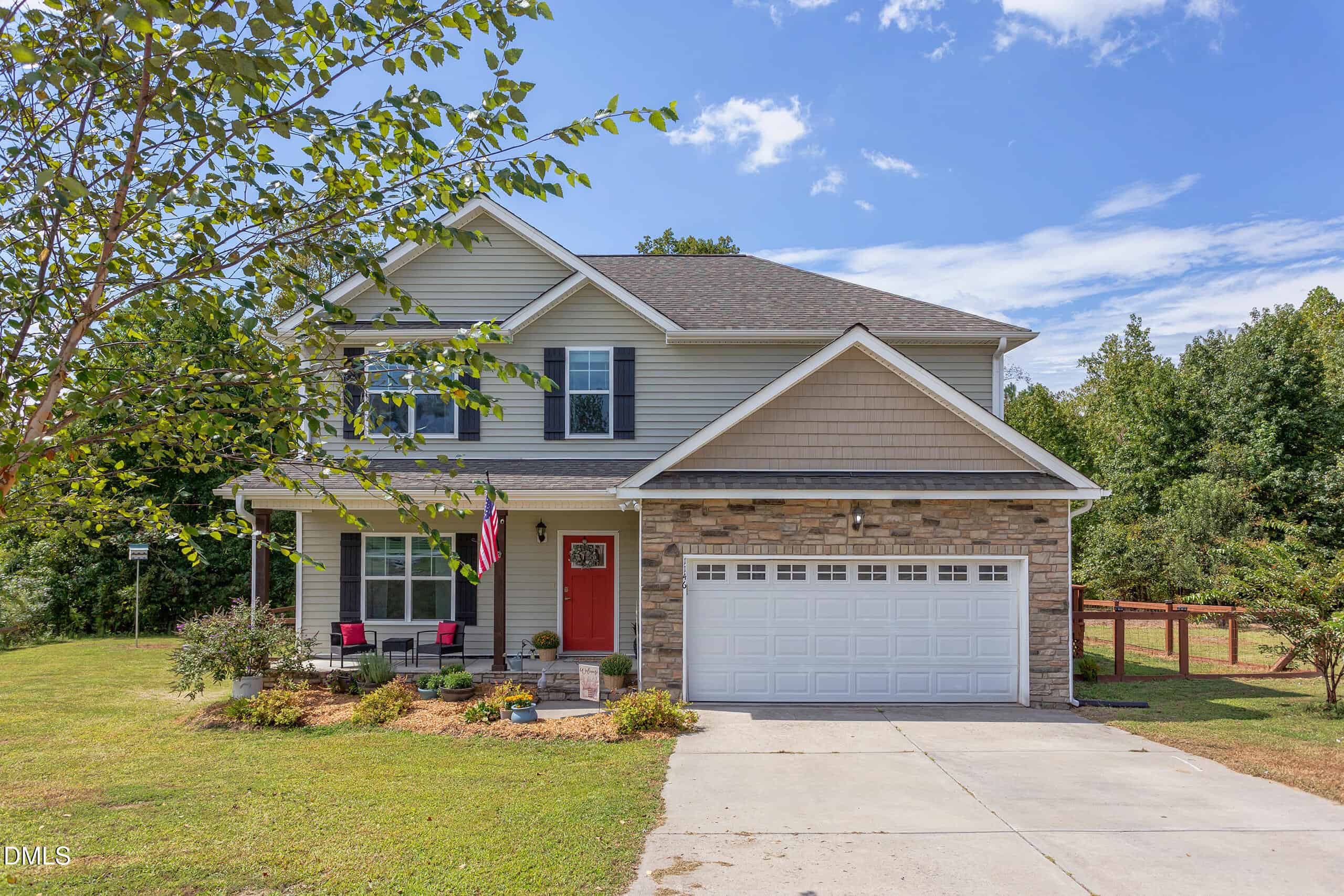 A charming house with a red door and a driveway located at 1146 Country Club Lane in Zebulon.