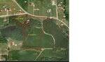 Aerial map shows two adjacent land parcels outlined in red: one labeled 2.43 acres along a road, and one labeled 14.75 Acre Perry Road, Zebulon, with woods and open land; nearby properties and houses marked with red dots.