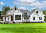 A modern, single-story house with white siding, stone accents, large windows, and a well-manicured lawn, set against a backdrop of trees and a blue sky. Text at the bottom states the image is for illustration purposes.