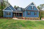 A modern single-family house with blue siding, white trim, and a brick foundation. The house has multiple gables, several windows, and a small covered front porch. The lawn is green with minimal landscaping.