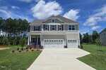 A house with a driveway and grass.