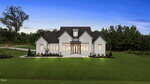 A modern two-story white house with large windows, a dark roof, and a spacious, neatly landscaped green lawn, set against a backdrop of trees under a clear evening sky.