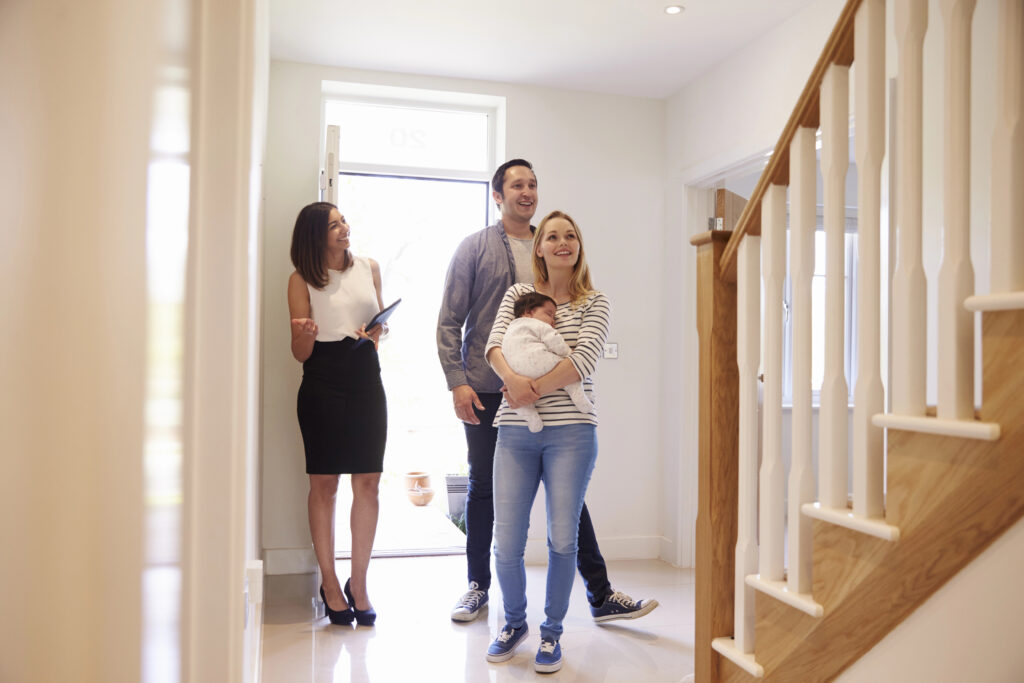 A couple touring a home with their real estate broker.