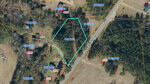 Aerial map showing a forested land parcel outlined in blue along Wise Haupf Rd, with surrounding parcels marked by yellow lines and various property numbers labeled in blue and red text.