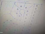 Faint blueprint-style image of the 27 Sagefield Dev in Henderson shows residential site plans with cul-de-sacs, rectangular lots, and circular symbols for trees or utilities. Dotted lines outline property boundaries.
