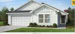 Located at 500 Purple Aster Street in Youngsville, this single-story white house features a gabled roof, two-car garage, horizontal siding, manicured lawn, bushes, and a paved driveway set against trees and a blue sky.