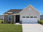 A modern single-story house at 212 Blue Sky Lane, Louisburg, featuring stone and light-colored siding, a dark front door, and a two-car garage. The home sits on a neatly manicured lawn under a clear blue sky.