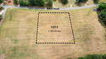 Aerial view of Lot 3 Reed Road, Castalia: a grassy 1.50-acre lot outlined with dashed lines, bordered by trees, with Reed Road running along the top edge.